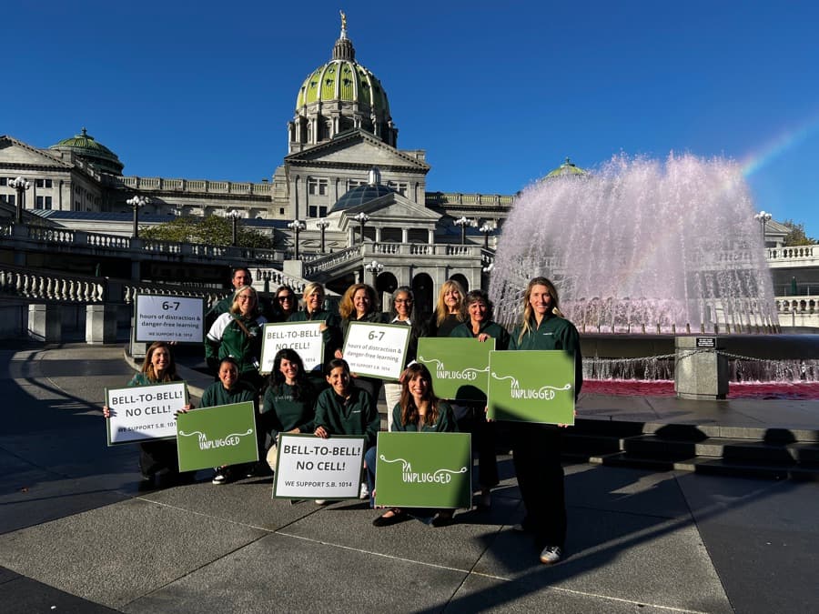 PA Unplugged members with bell-to-bell signs at the Capitol in Harrisburg